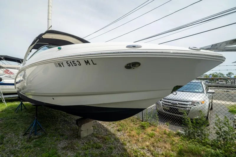Slide: The Image of 2015 Chaparral 287 SSX boat on display, elevated on stands, with registration number visible. - 3