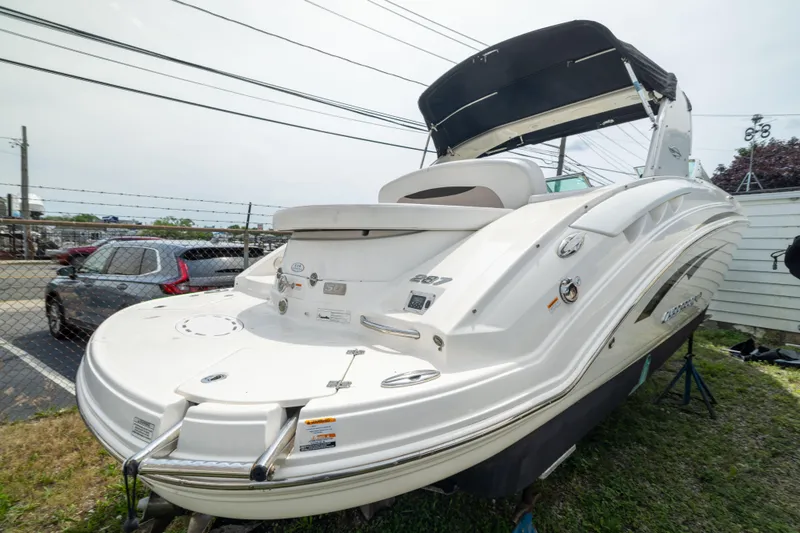 Slide: The Image of 2015 Chaparral 287 SSX boat with sleek design, parked outdoors. - 4