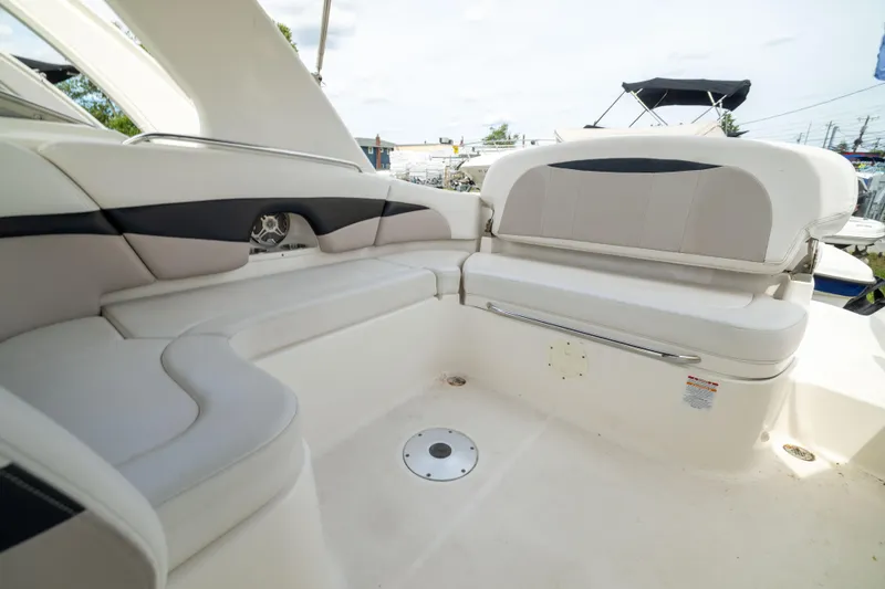 Slide: The Image of Interior seating of 2015 Chaparral 287 SSX boat, featuring white and gray upholstery. - 7