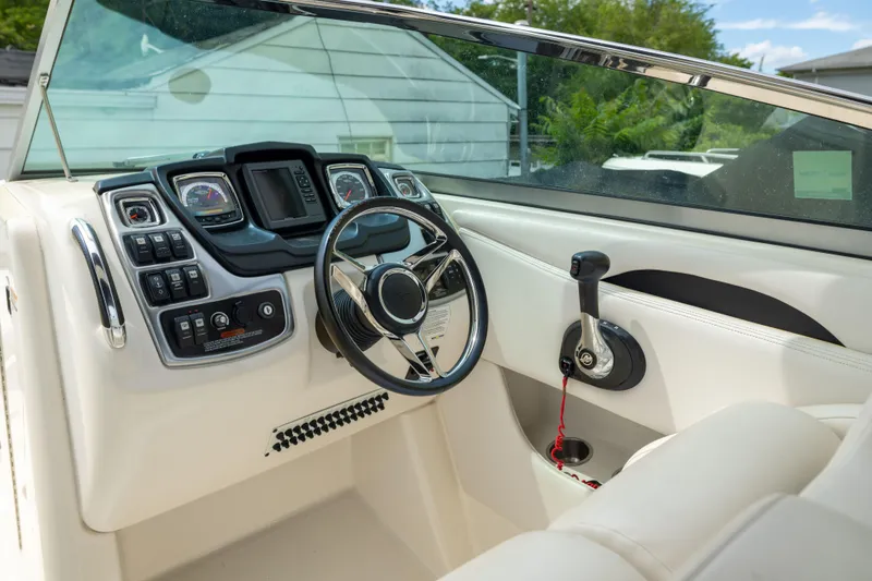 Slide: The Image of 2015 Chaparral 287 SSX boat dashboard with steering wheel and control panel. - 8