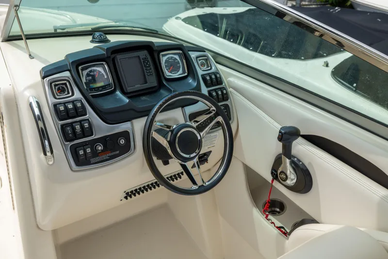 Slide: The Image of Cockpit of 2015 Chaparral 287 SSX boat with steering wheel and control panel. - 9