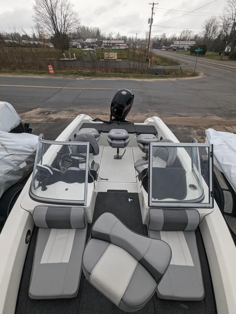 Slide: The Image of 2024 Triton 186 Allure boat interior with dual consoles and seating. - 12