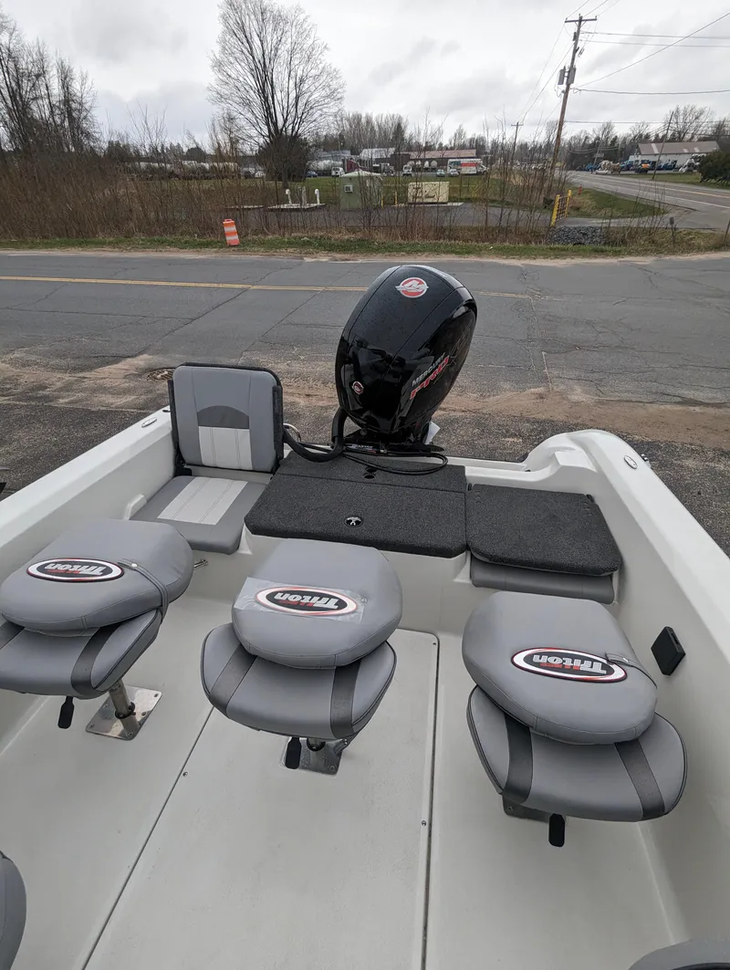 Slide: The Image of 2024 Triton 186 Allure fishing boat with seating and outboard motor. - 14