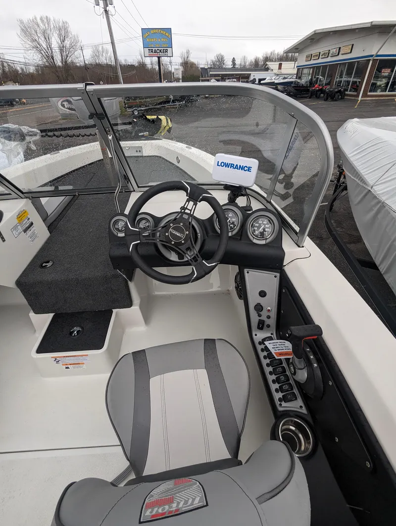 Slide: The Image of 2024 Triton 186 Allure boat cockpit with steering wheel and control panel. - 15