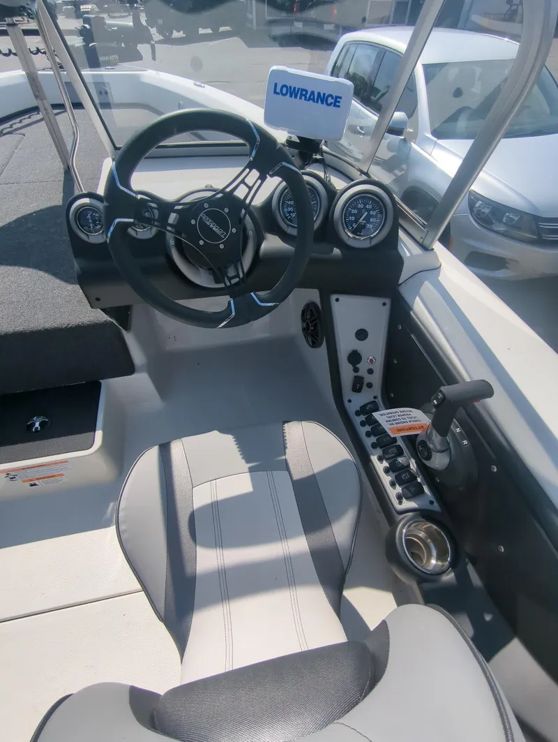 Slide: The Image of 2024 Triton 186 Allure boat cockpit with steering wheel and control panel. - 3