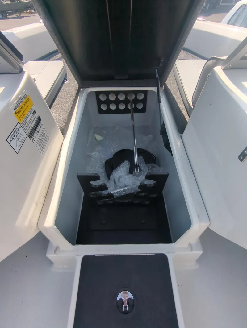 Slide: The Image of 2024 Triton 186 Allure boat storage compartment with open lid. - 6