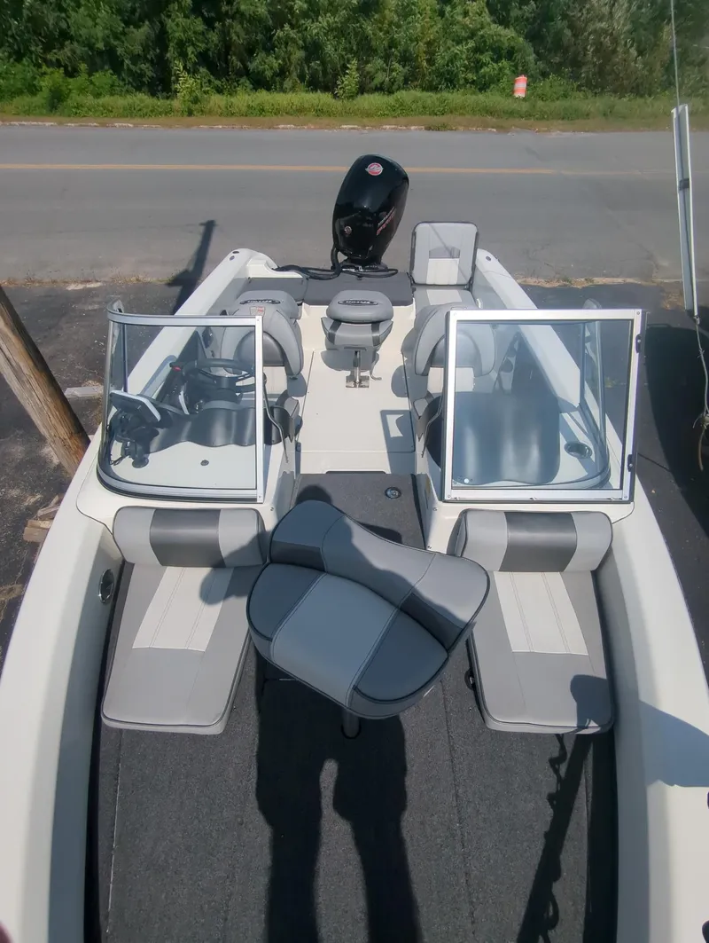 Slide: The Image of 2024 Triton 186 Allure boat with open seating and dual consoles. - 7