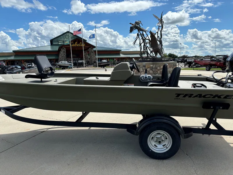 The Image of 2024 Tracker Grizzly 1754 SC boat on trailer outside Cabela's store. - 0