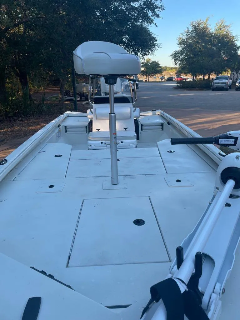 Slide: The Image of 2024 Ranger RB200 boat with spacious deck and seating, parked outdoors. - 6