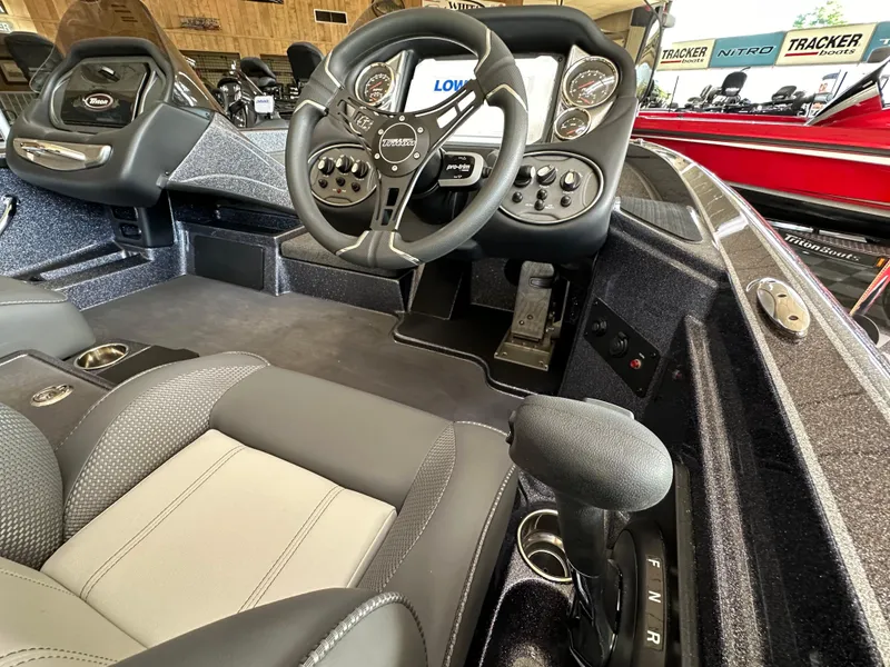 Slide: The Image of 2024 Triton 18 TrX boat interior with steering wheel and control panel. - 5