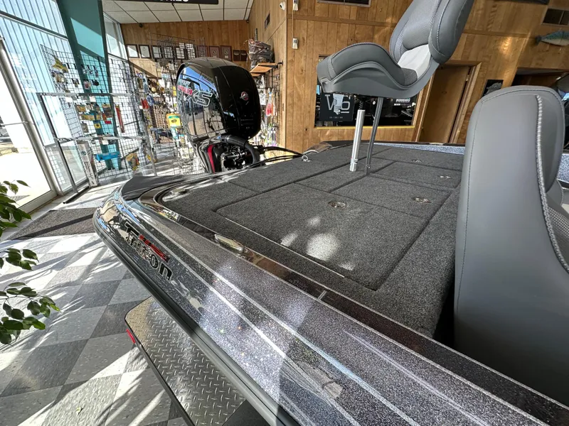 Slide: The Image of 2024 Triton 18 TrX bass boat on display in showroom. - 6