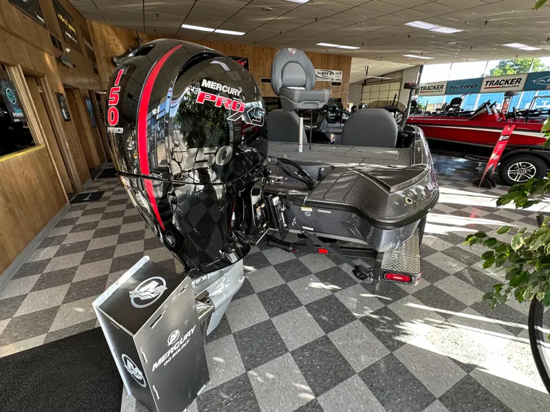 Slide: The Image of 2024 Triton 18 TrX bass boat with Mercury Pro XS 150 outboard motor in showroom. - 7