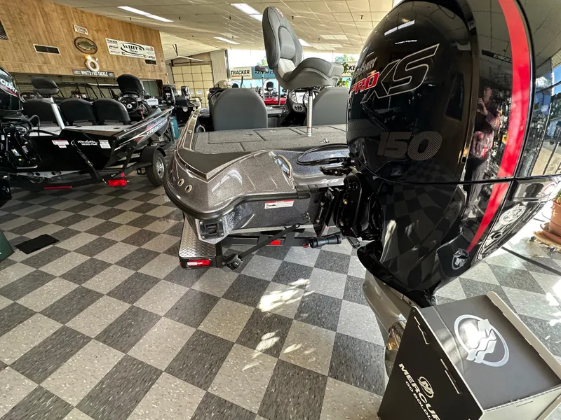 Slide: The Image of 2024 Triton 18 TrX bass boat with Mercury 150 engine in showroom. - 8