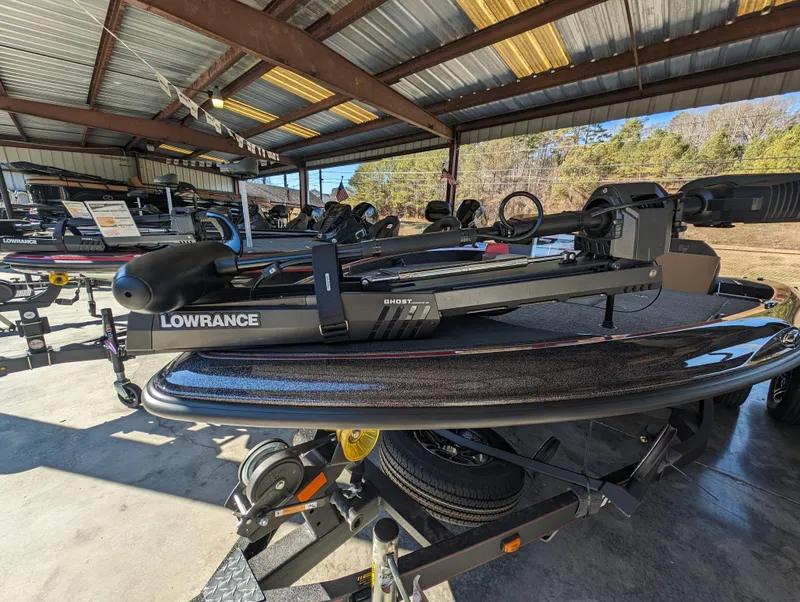 Slide: The Image of 2024 Triton 18 TrX boat with Lowrance equipment in a covered storage area. - 4
