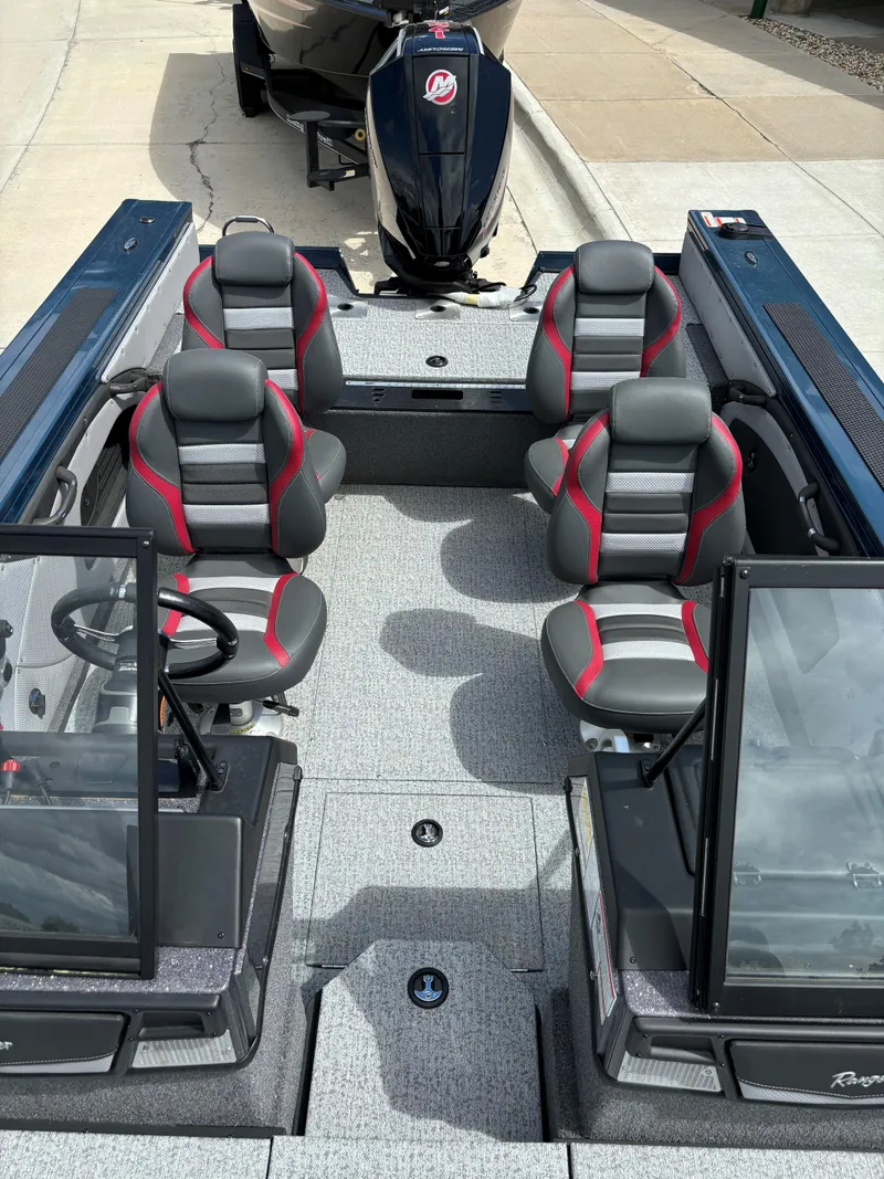Slide: The Image of 2024 Ranger VX1788 WT boat interior with four seats and a motor. - 3
