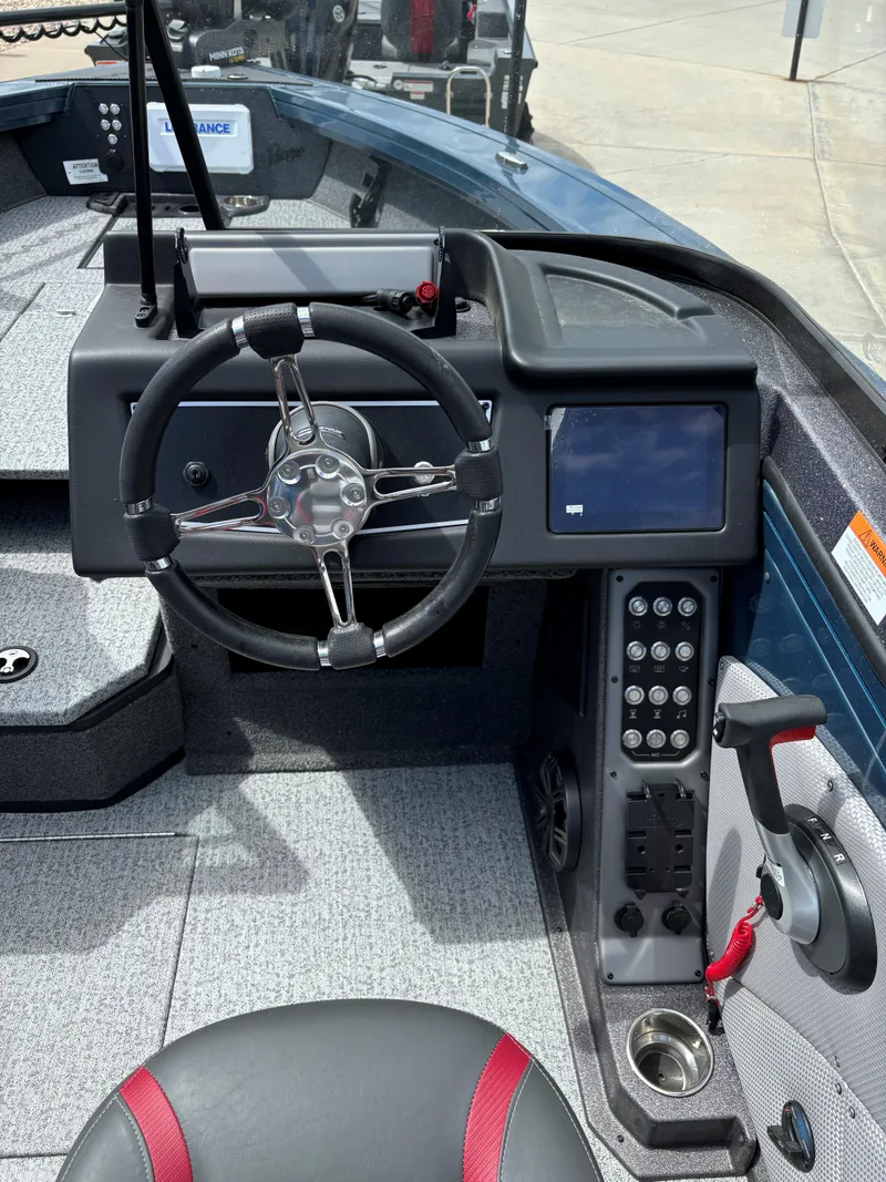 Slide: The Image of 2024 Ranger VX1788 WT boat cockpit with steering wheel, control panel, and navigation screen. - 6