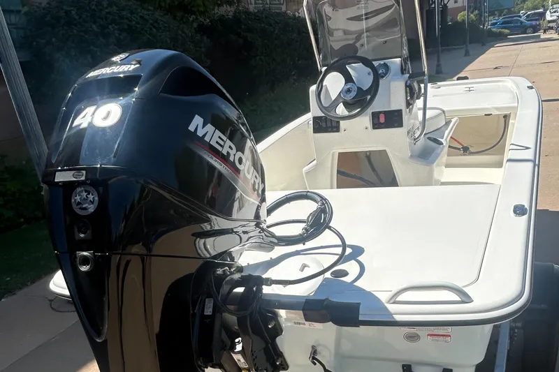 Slide: The Image of 2024 Mako Pro Skiff 13 CC with Mercury 40 outboard engine, white interior. - 2