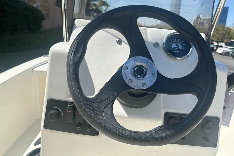 Slide: The Image of Steering wheel of 2024 Mako Pro Skiff 13 CC boat with dashboard controls. - 3