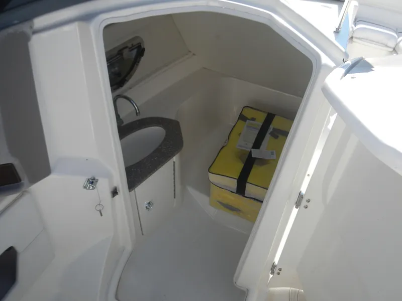 Slide: The Image of 2009 Larson 238 LXi boat interior cabin with sink and storage. - 13