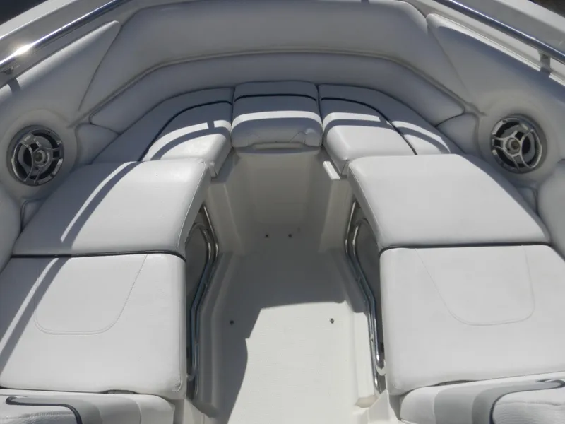 Slide: The Image of 2009 Larson 238 LXi boat interior with white cushioned seating. - 6