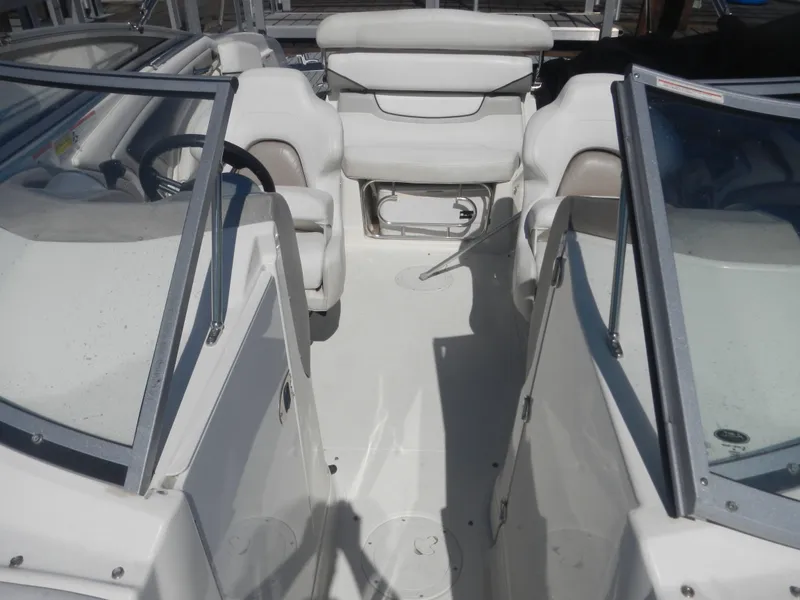 Slide: The Image of 2009 Larson 238 LXi boat interior with white seating and dual consoles. - 7