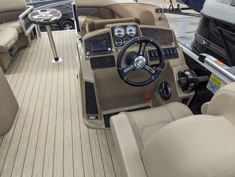 Slide: The Image of 2024 Sylvan Mirage Fish 8522 Party Fish boat interior with steering console and seating. - 10