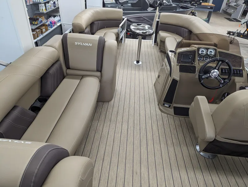 Slide: The Image of 2024 Sylvan Mirage Fish 8522 Party Fish interior with beige and brown seating. - 11