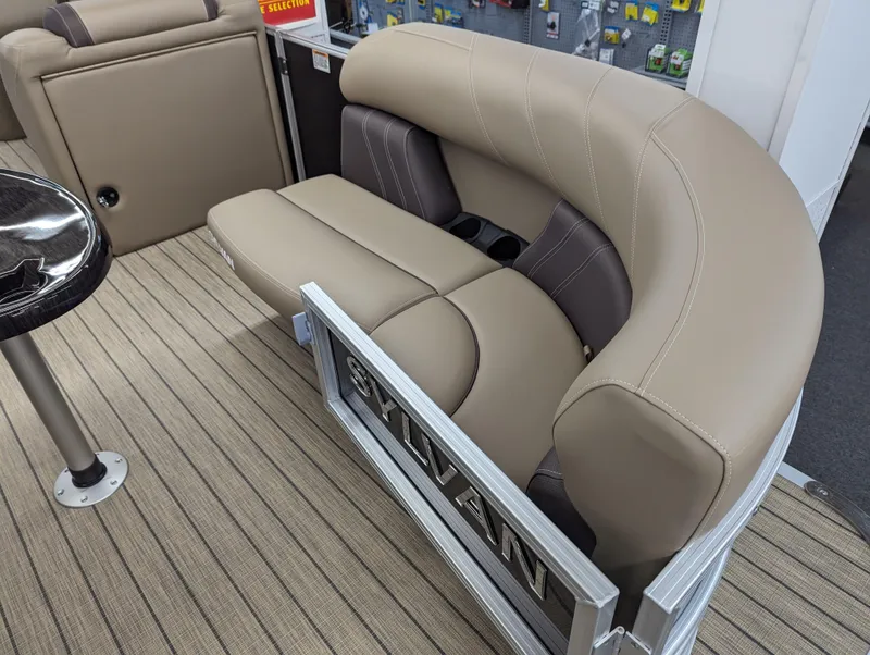 Slide: The Image of 2024 Sylvan Mirage Fish 8522 Party Fish boat interior seating with beige and brown upholstery. - 3