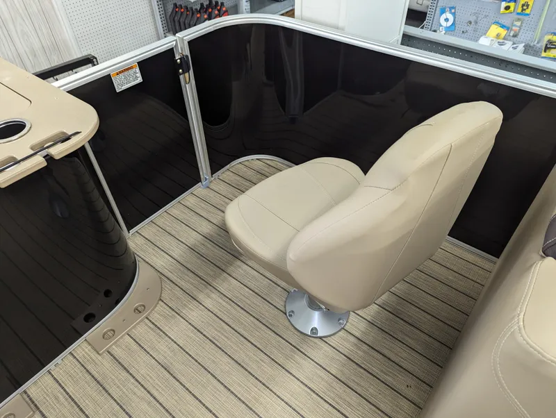 Slide: The Image of 2024 Sylvan Mirage Fish 8522 Party Fish boat interior with beige seating and striped flooring. - 7