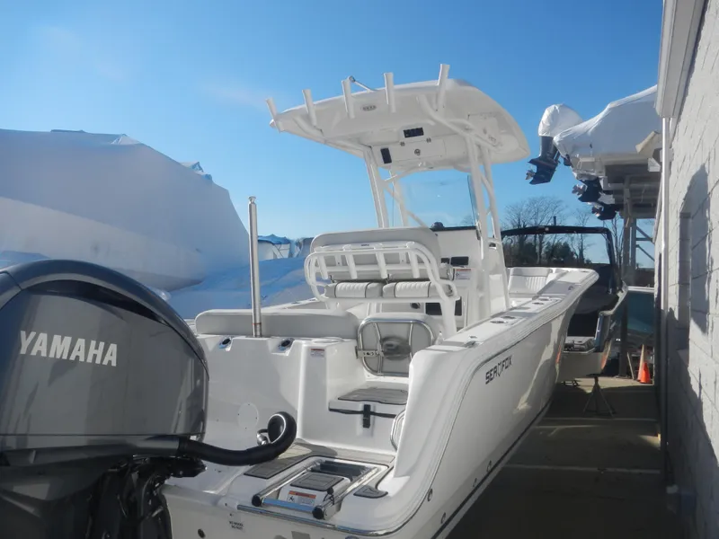 Slide: The Image of 2024 Sea Fox 248 Commander boat with Yamaha engine, docked outdoors. - 3