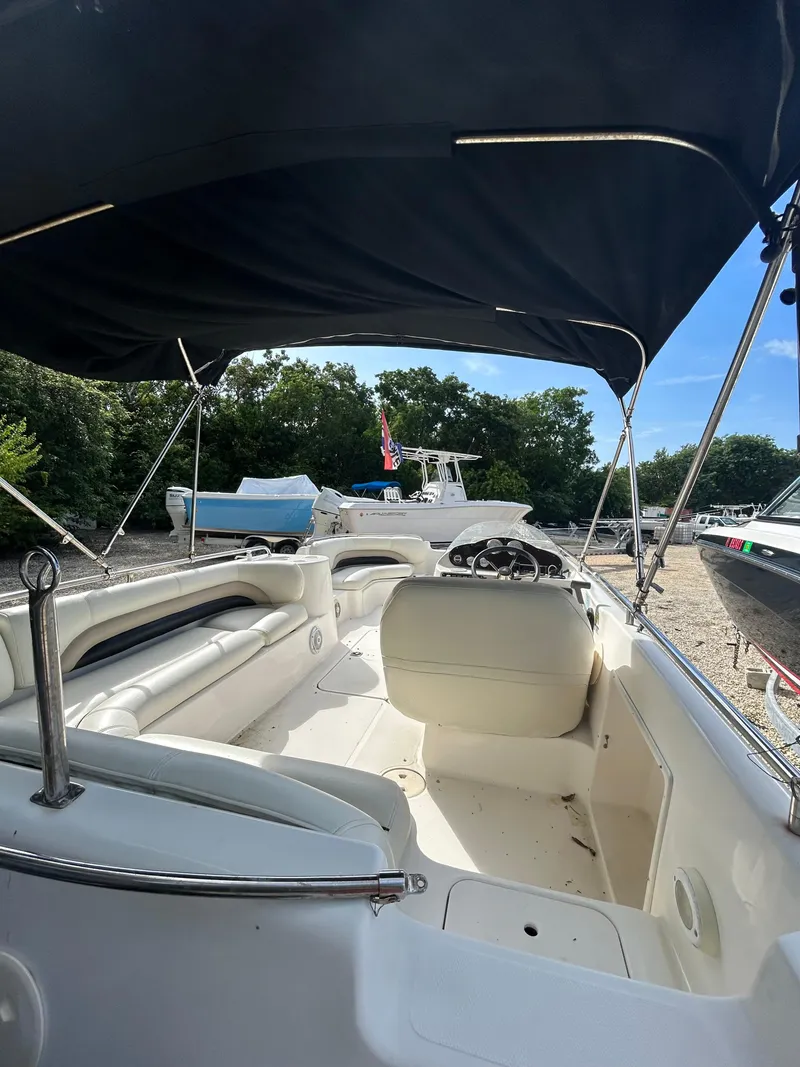Slide: The Image of 2004 Hurricane 201 boat interior with canopy, parked on a sunny day. - 3