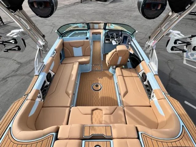 Slide: The Image of 2024 MasterCraft XT23 boat with sleek design, parked outdoors. - 11