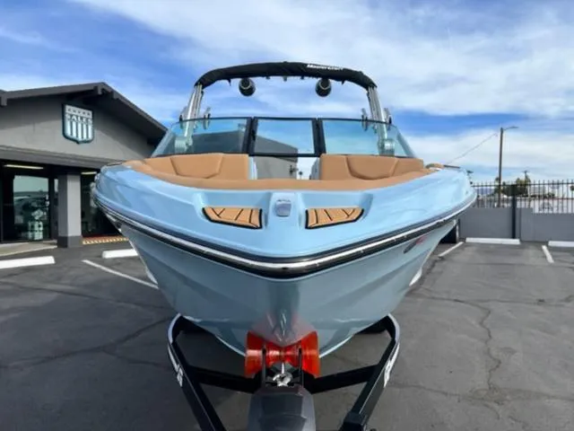 Slide: The Image of 2024 MasterCraft XT23 boat floating in a clear blue pool. - 3