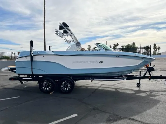 Slide: The Image of 2024 MasterCraft XT23 boat in a pool, showcasing sleek design and modern features. - 5