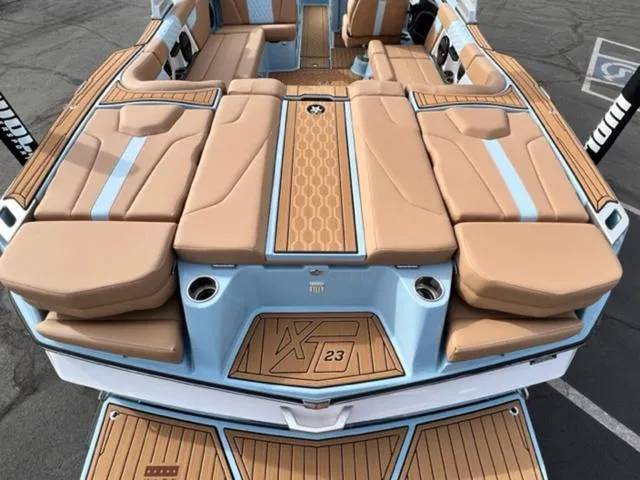 Slide: The Image of 2024 MasterCraft XT23 boat on trailer, parked outside dealership. - 9