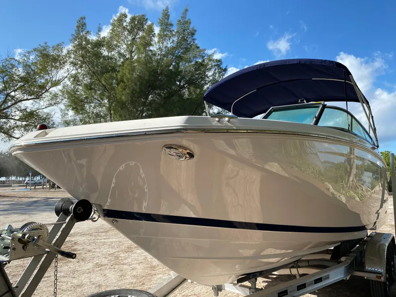 Slide: The Image of 2017 Regal 22 FasDeck boat on trailer with blue canopy. - 18