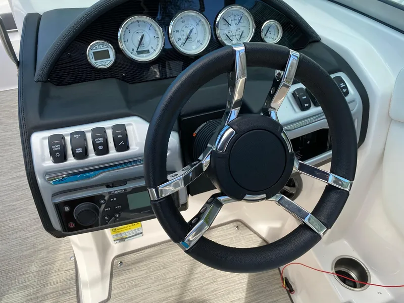 Slide: The Image of 2017 Regal 22 FasDeck boat dashboard with steering wheel and gauges. - 20