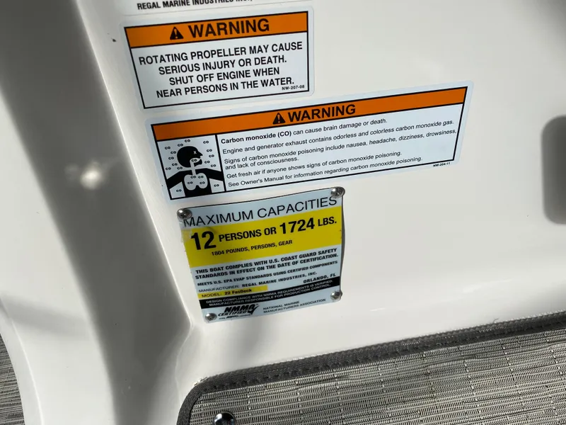Slide: The Image of Warning labels and capacity limits on a 2017 Regal 22 FasDeck boat. - 23