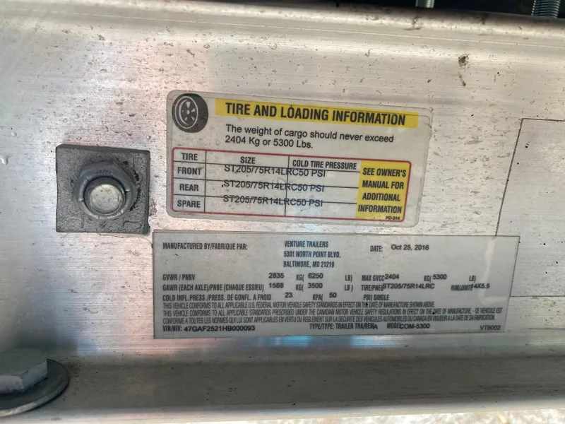 Slide: The Image of Tire and loading information label on a 2017 Regal 22 FasDeck boat trailer. - 25