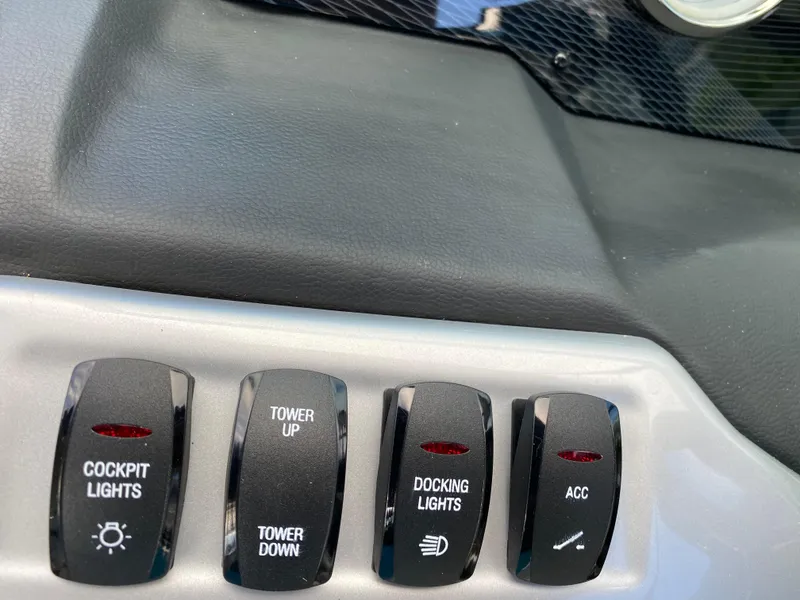 Slide: The Image of Close-up of control switches on a 2017 Regal 22 FasDeck boat. - 26