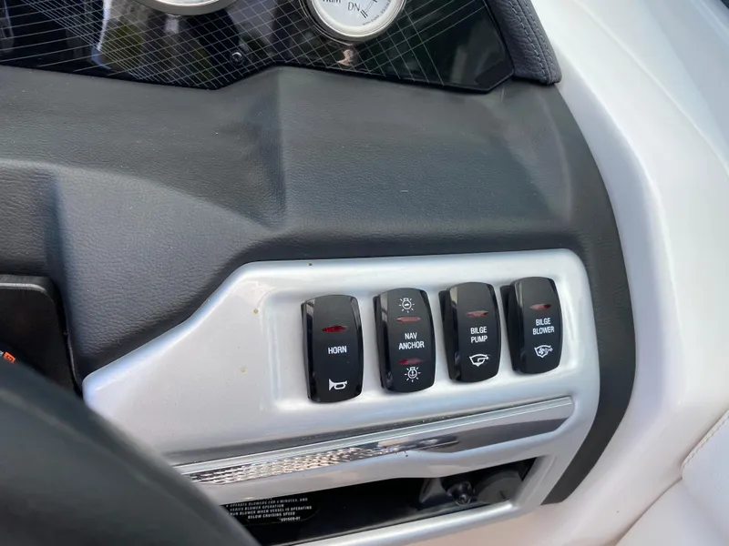 Slide: The Image of Control panel of a 2017 Regal 22 FasDeck boat with various switches. - 27
