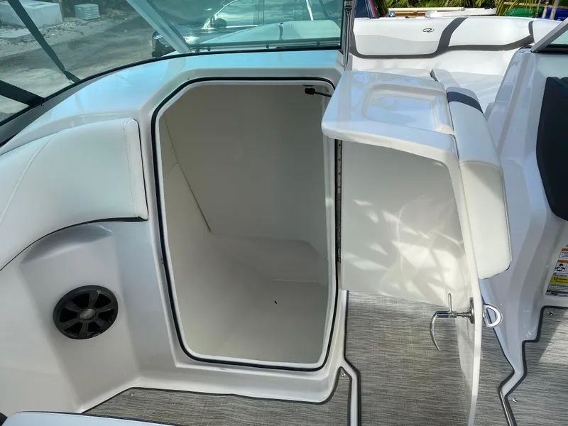 Slide: The Image of 2017 Regal 22 FasDeck boat interior storage compartment with open door. - 32
