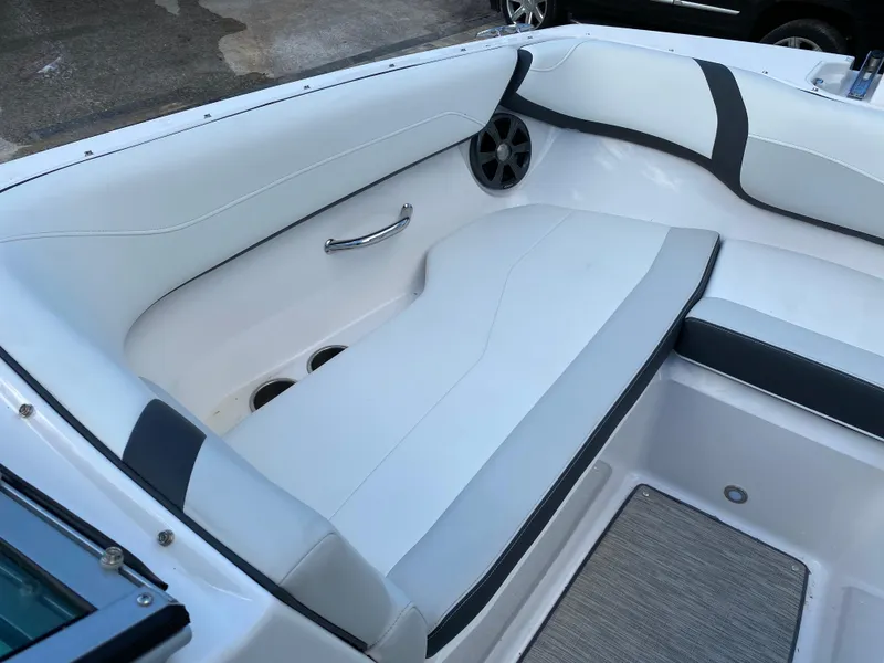 Slide: The Image of 2017 Regal 22 FasDeck boat interior seating with cup holders and speaker. - 37