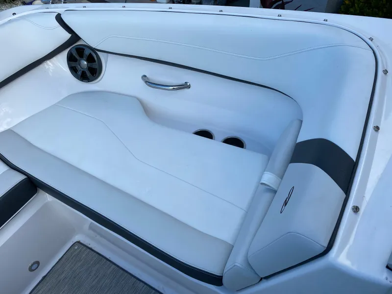 Slide: The Image of 2017 Regal 22 FasDeck boat interior seating with speaker and cup holders. - 38
