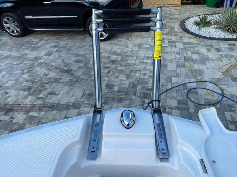Slide: The Image of 2017 Regal 22 FasDeck boat ladder on paved driveway. - 42