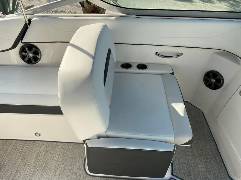 Slide: The Image of 2017 Regal 22 FasDeck boat interior seating with cup holders and speakers. - 49