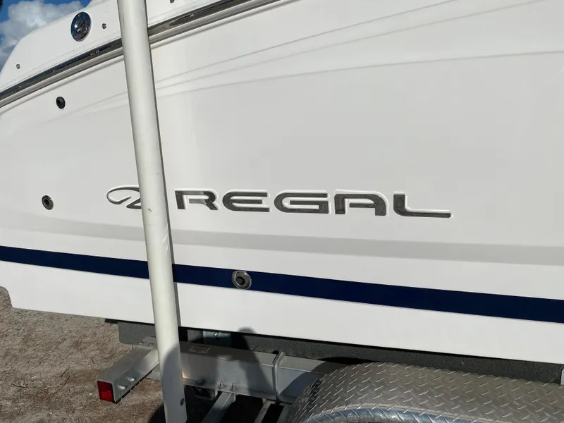 Slide: The Image of 2017 Regal 22 FasDeck boat side view with logo. - 8