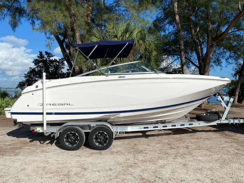Slide: The Image of 2017 Regal 22 FasDeck boat on trailer, side view, outdoors. - 9