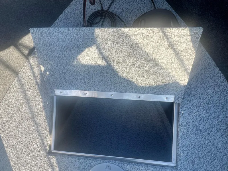 Slide: The Image of Open storage compartment on a 2024 Starweld 18 Fusion boat. - 27