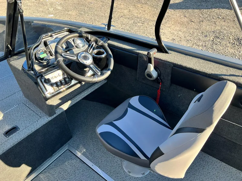 Slide: The Image of 2024 Starweld 18 Fusion boat cockpit with steering wheel and captain's chair. - 33